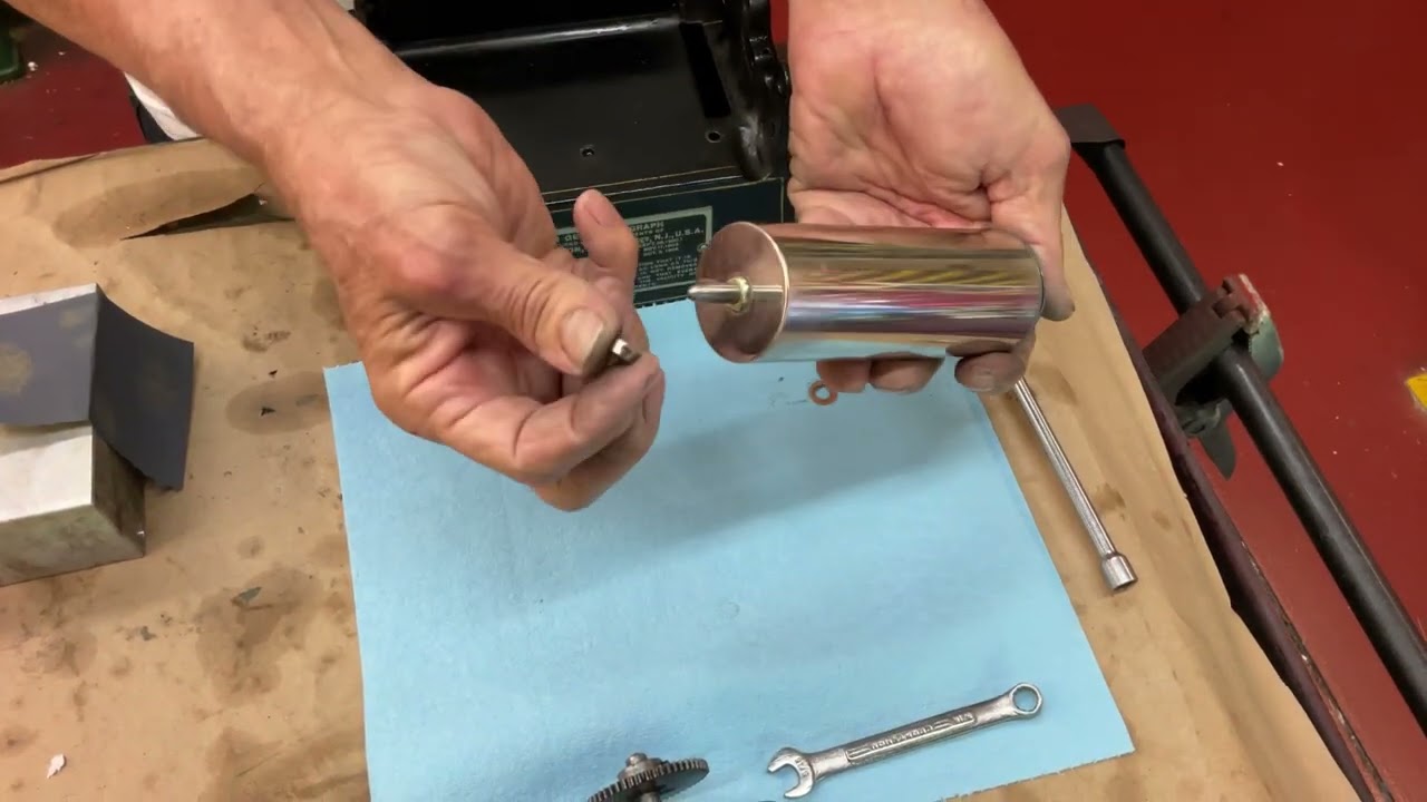 1098.  Installing the mandrel and mandrel shaft on an Edison Gem phonograph￼