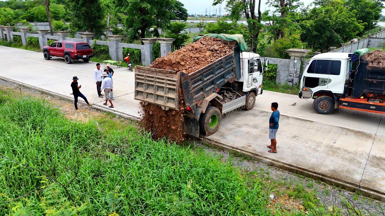 Starting New Project Many Dump Truck Traffic jams Waiting Unloading Dirt And Dozer Push The Soil
