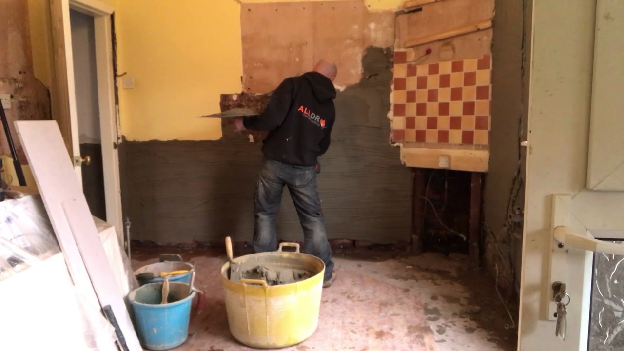 Applying Renderlite salt inhibiting plaster after DPC installation