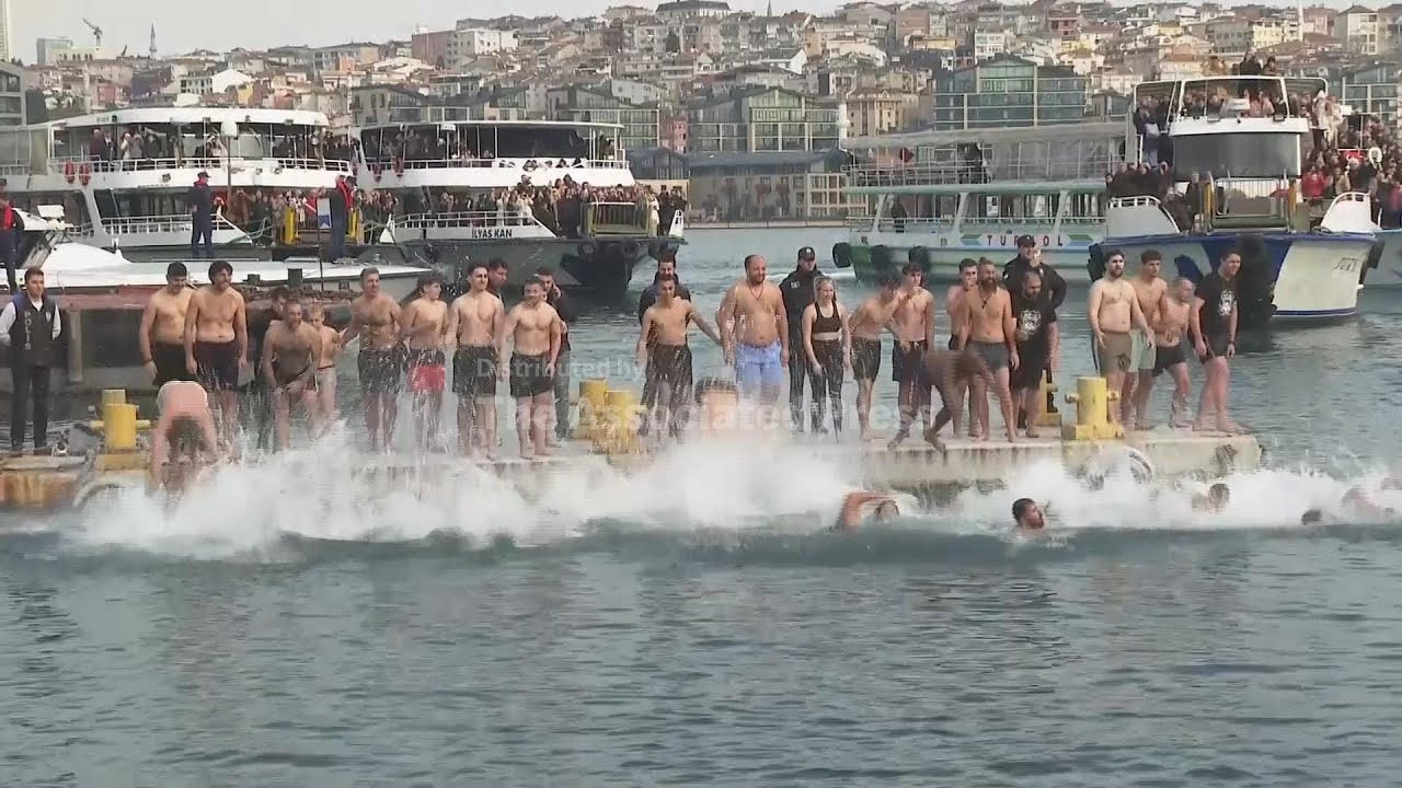 Orthodox Christians plunge into waters of Istanbul&rsquo;s Golden Horn to retrieve a crucifix