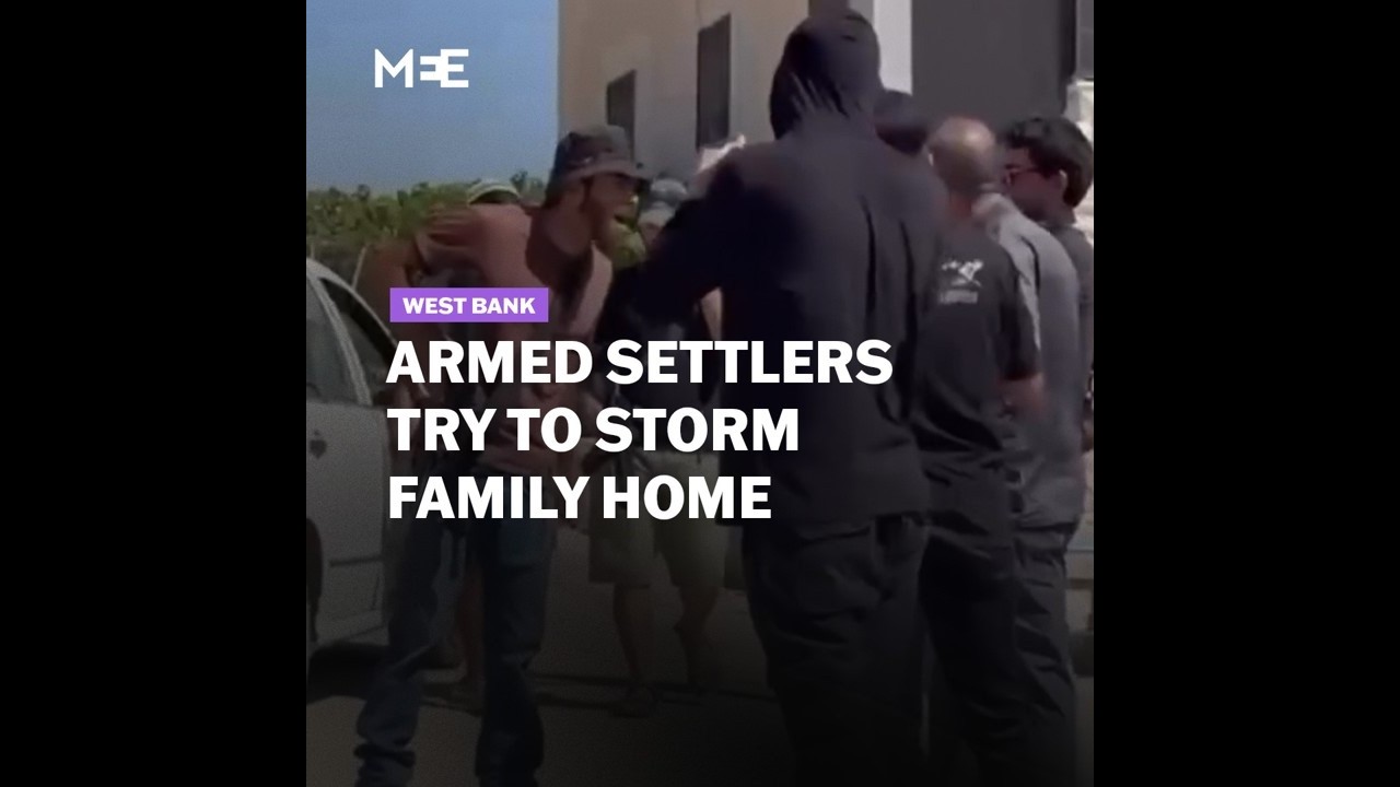 Armed settlers, protected by Israeli forces, attempt to storm a Palestinian family's home