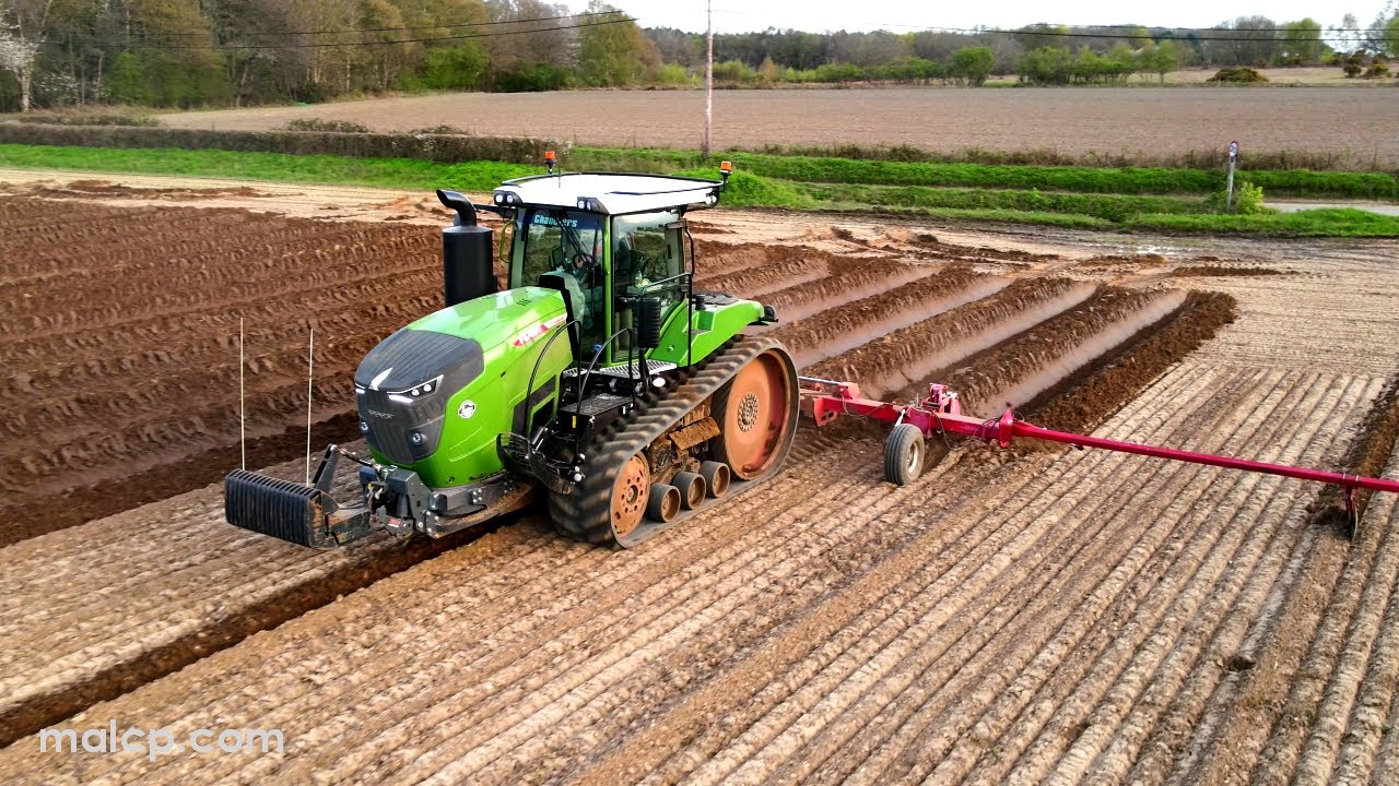 4k Fendt 943 Vario MT with a Grimme 4 furrow ridger after sunset in Suffolk