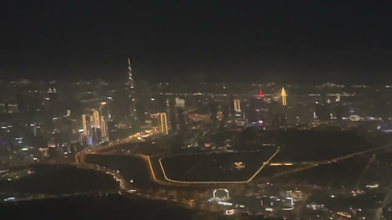 Emirates Boeing 777-300er night descending over Dubai. Stunning Burj Khalifa and Cityviews
