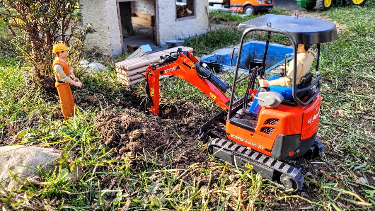 Thuya hedge removal and log palisade installation, RC mini excavator Kubota Hutter U17