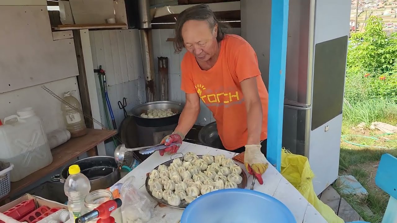 Cooking a classic Mongolian dish in an outdoor kitchen while visiting a longtime friend and pastor