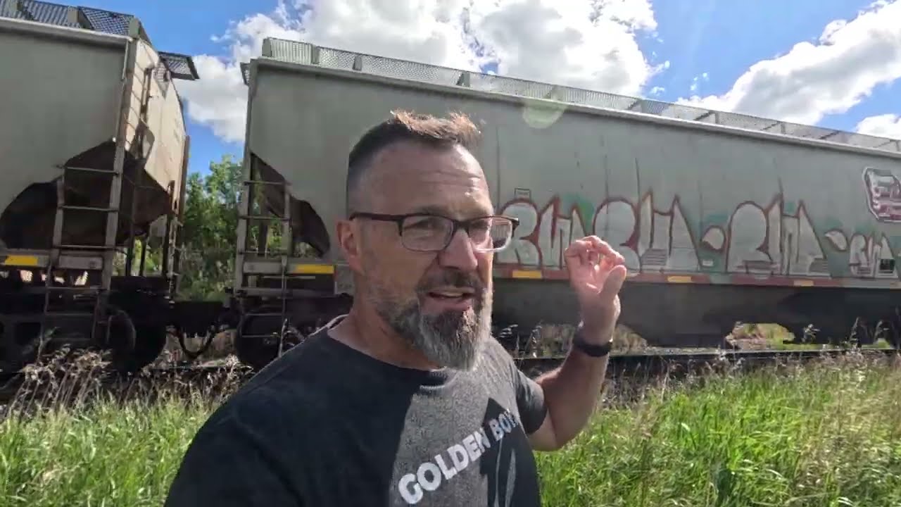 Grain unit train rolling along the Bow River