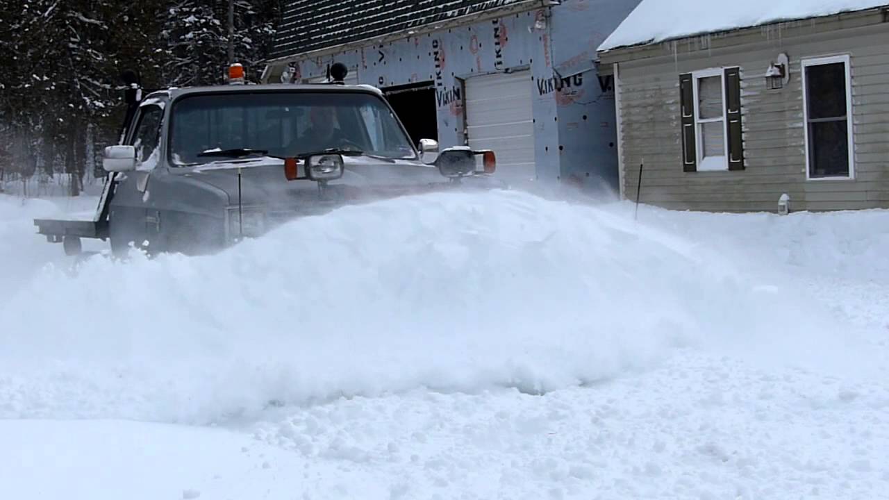 Chevy K20 flatbed plowing snow w/chains