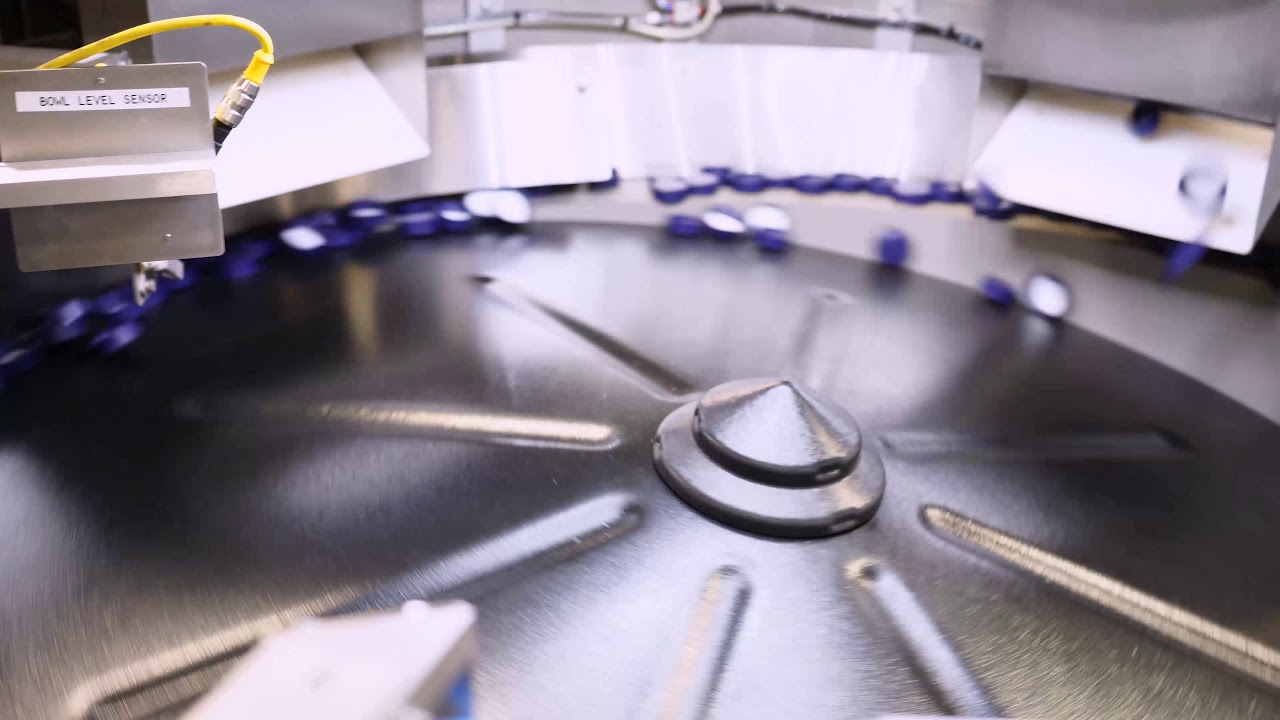 Centrifugal feeder for caps