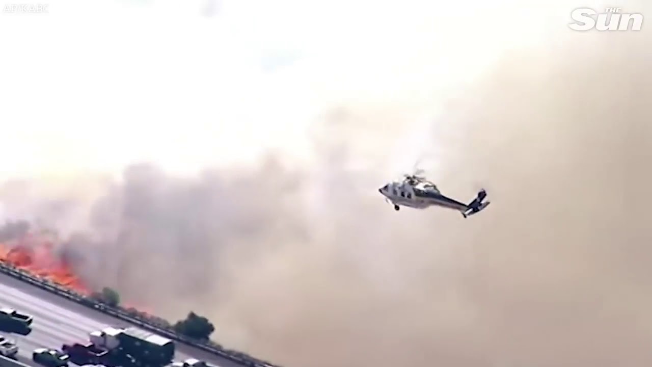 Watch motorist fleeing from California camp fire: helicopter protect them