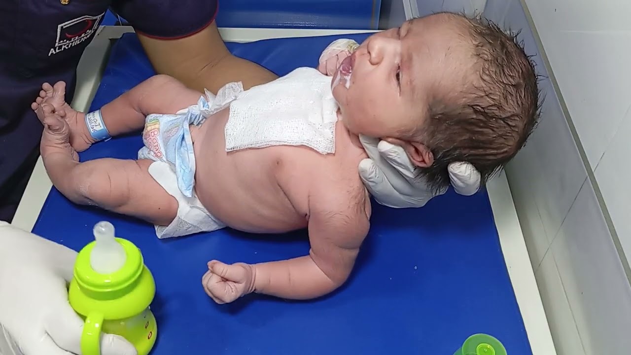 New born baby and there first feed strong suck 