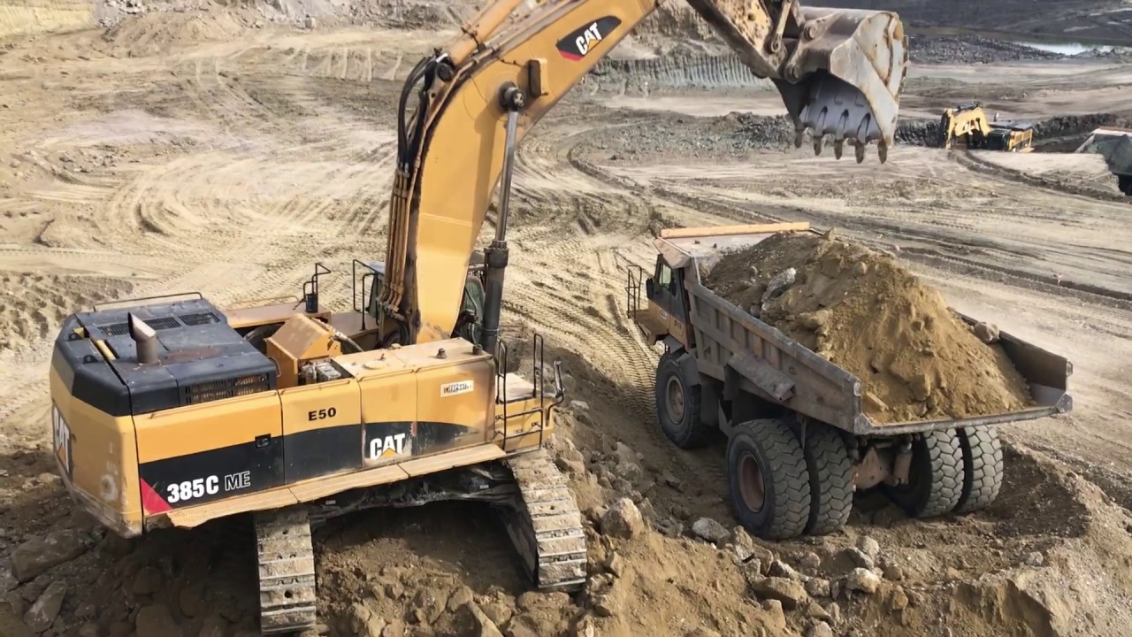 Caterpillar 385C Excavator Loading Caterpillar Dumpers