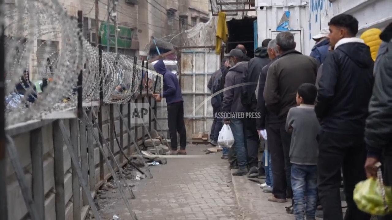 Palestinians in northern Gaza wait for hours to buy a pack of bread