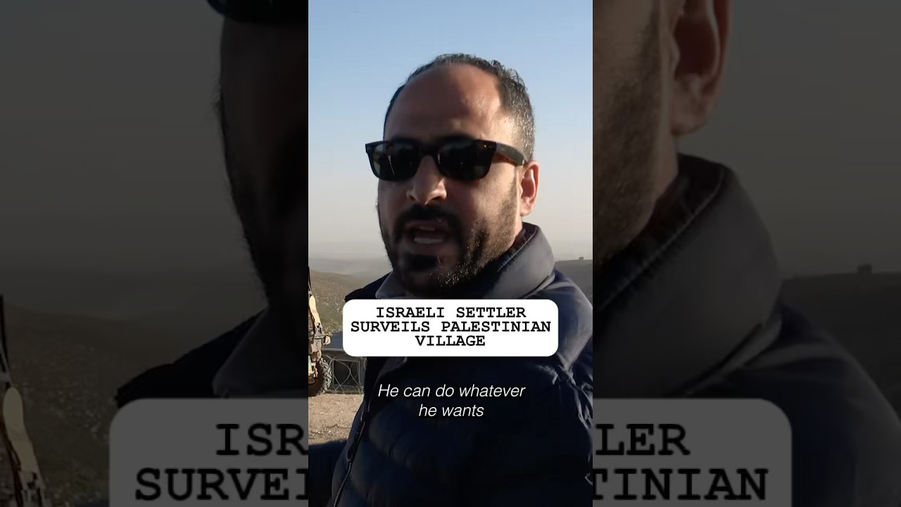 Israeli Settler Surveils Palestinian Village