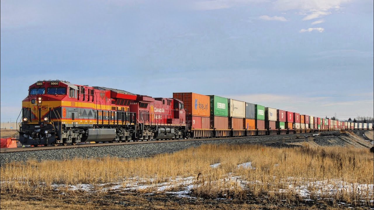 KCS 5000 leading CP Stack train Westbound at Ogden on the Brooks Subdivision.