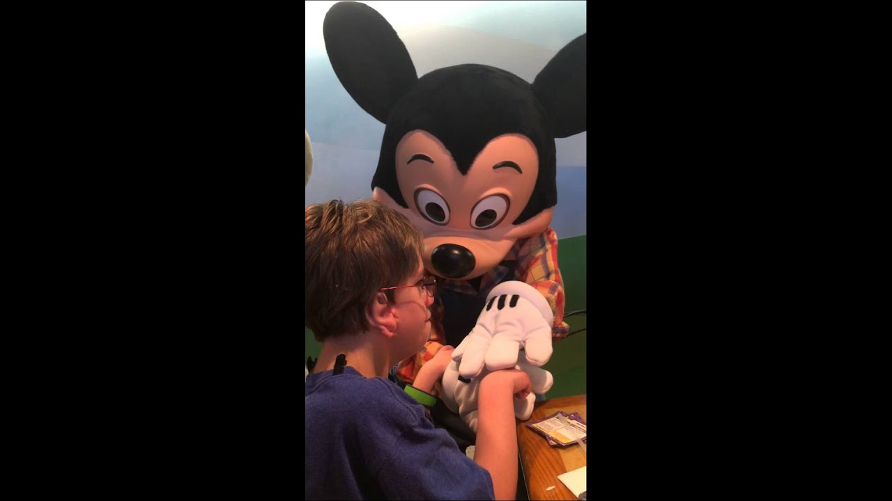 Deaf boy communicating with Mickey for the first time