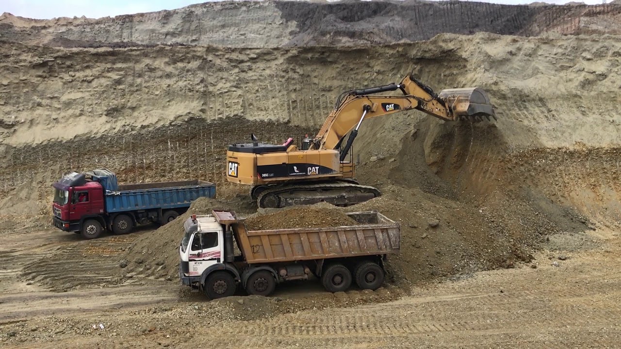 Caterpillar 385C Excavator Loading Mercedes And Man Trucks