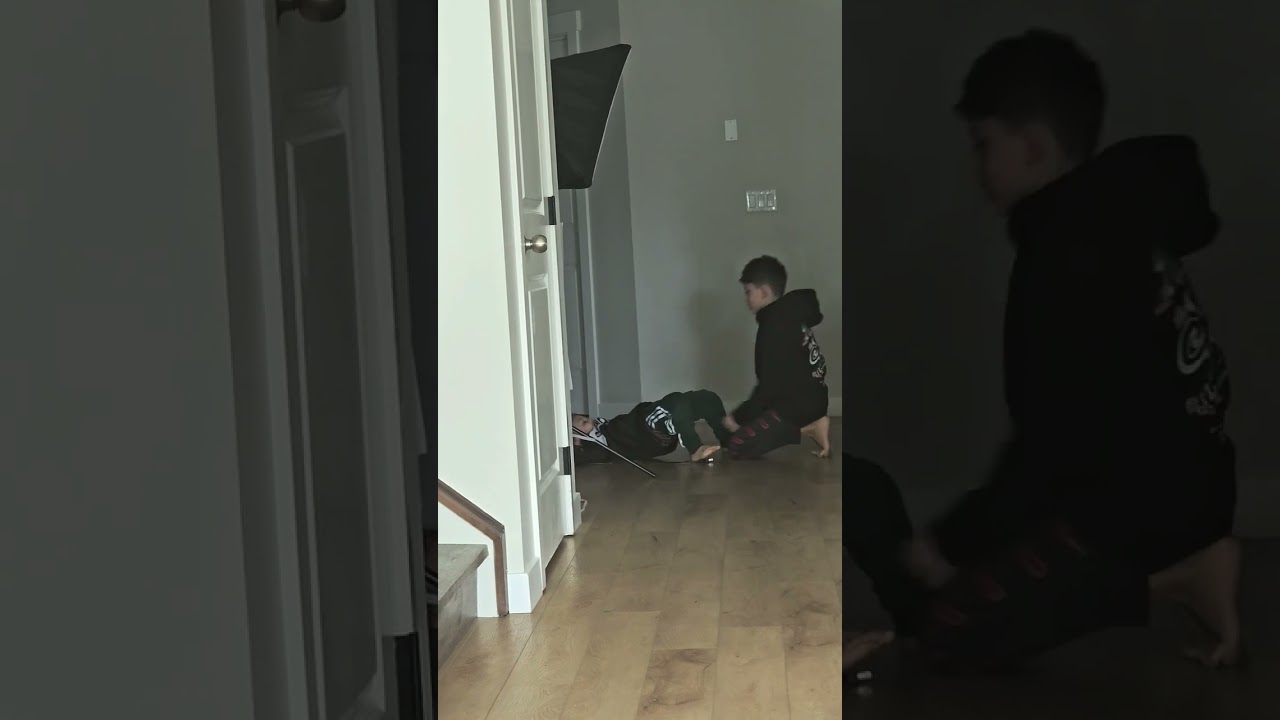 OLDER BROTHER HELPING THE BABY GET DRESSED