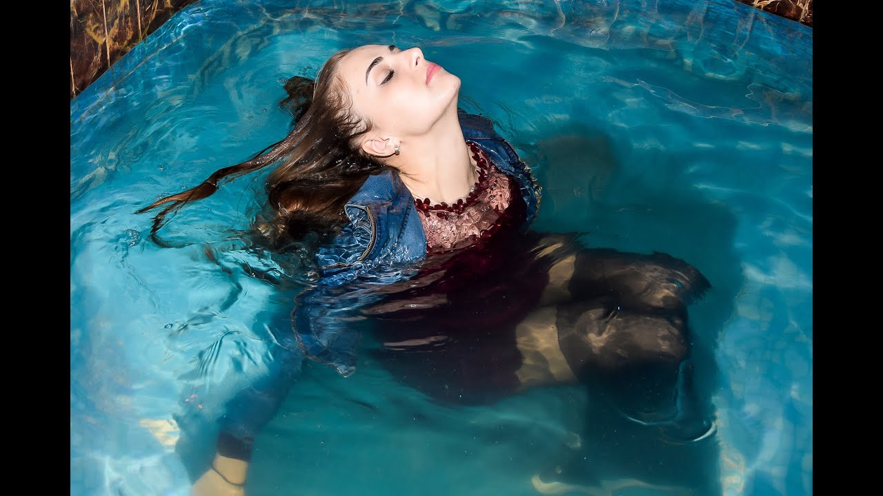 cute student poses in wet clothes in the pool after lectures for wetlook video
