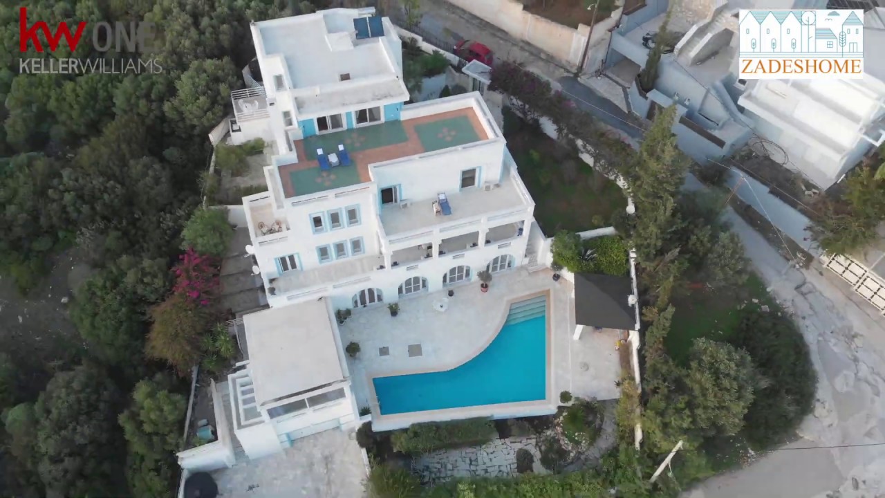 The Villa is a large home (700 sq meters;) nested in a hillside right on the Aegean Sea
