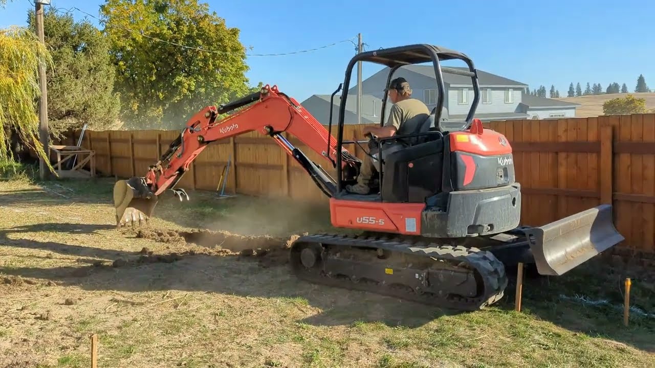 Kubota U55-5 5-ton mini excavator doing some trenching digging 4K