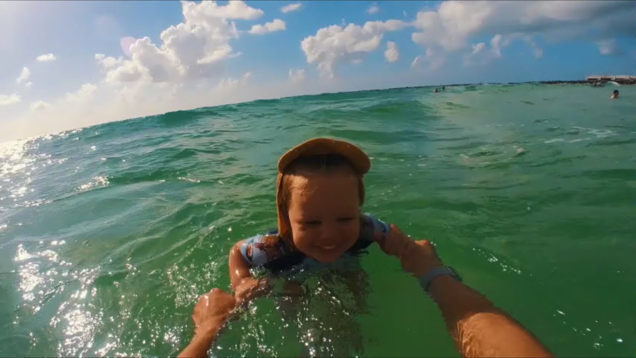 Naomi is swimming on her back for first time in the Ocean at Miami Beach