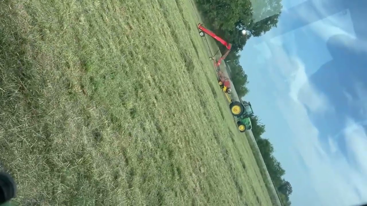 Running hay grappler with 15 bale accumulator behind John Deere and new holland baler