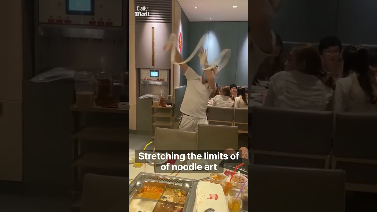 Restaurant worker stretches noodle by dancing with it