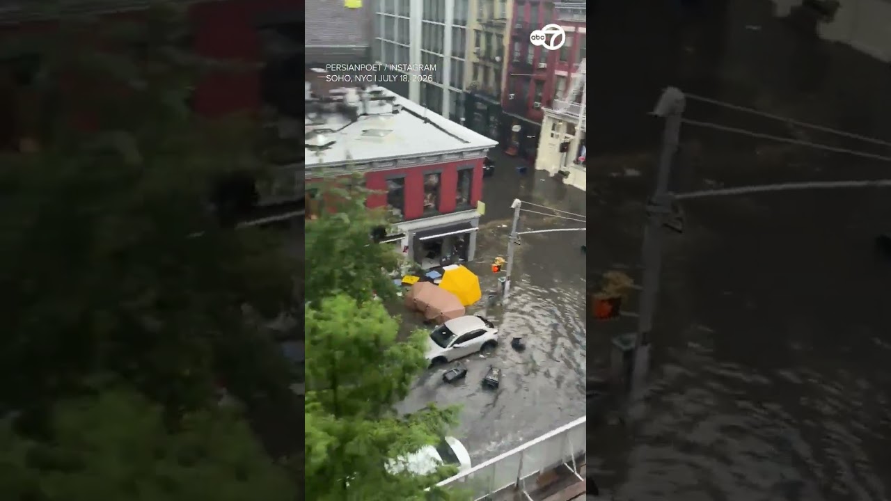 Driver wades through waist high floodwater after vehicle gets stuck