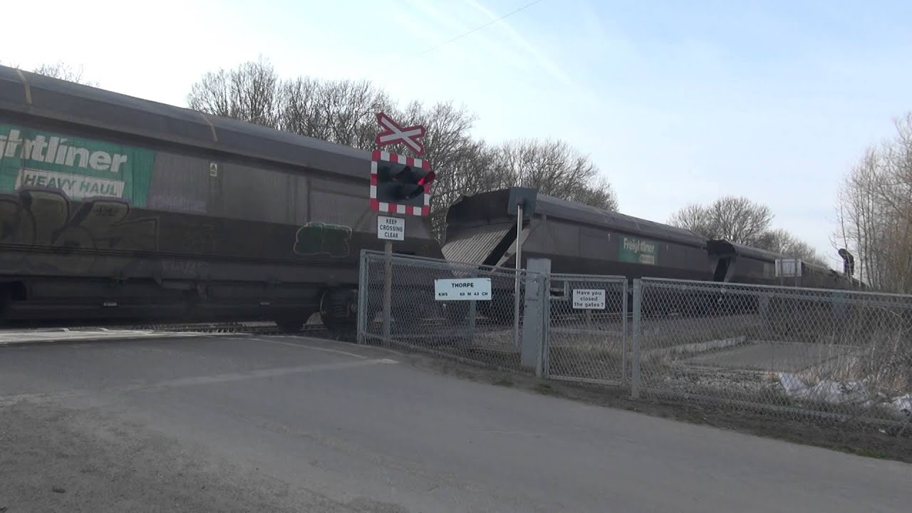66616 restarts it train at Thorpe level crossing