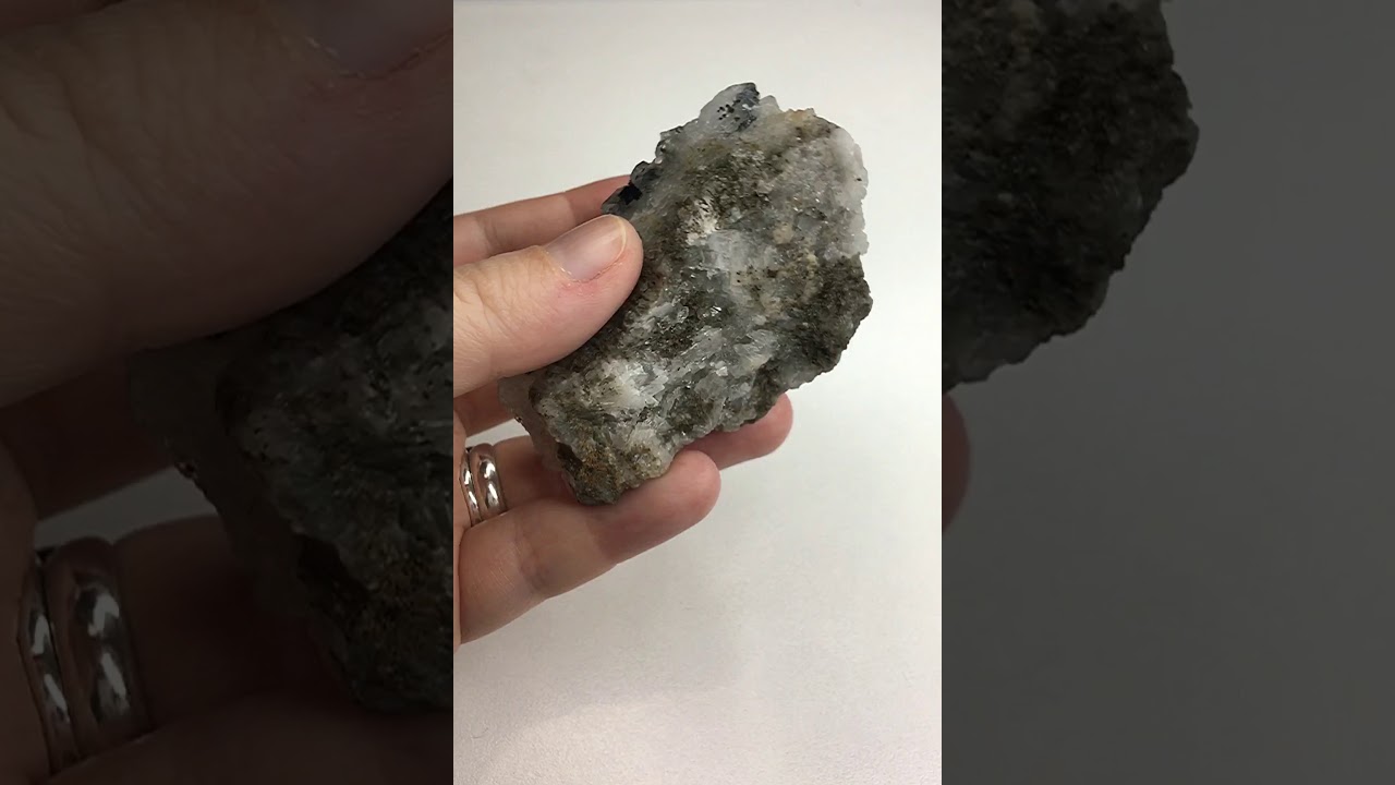 Druse of quartz with inclusions of black stone