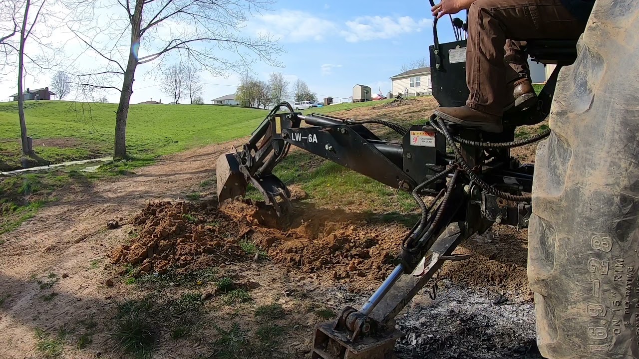Titan LW-6 Backhoe and Kubota Tractor cleaning a Ditch! Not my favorite attachment!