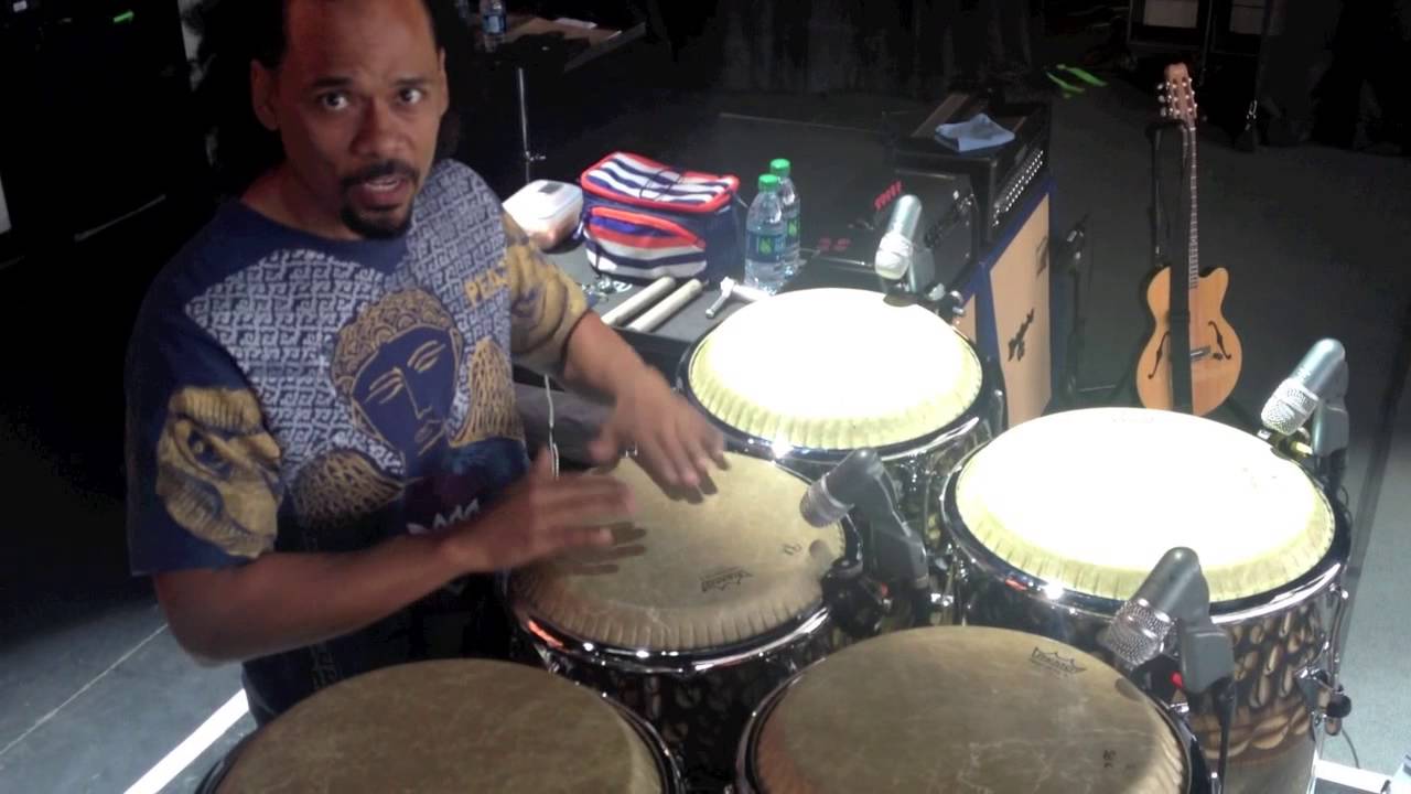 Paoli Mejias tuning congas in Santana band with Chad Tasky