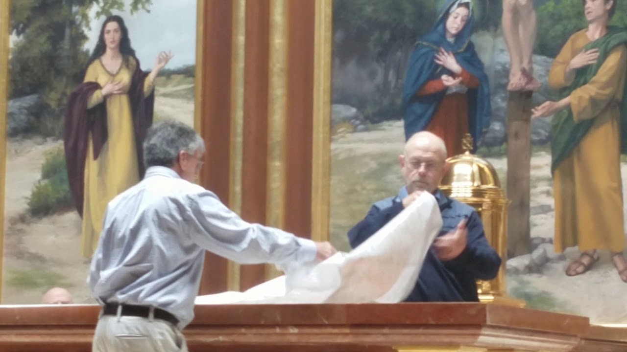 Dressing a new altar in its altar cloth for the first time.
