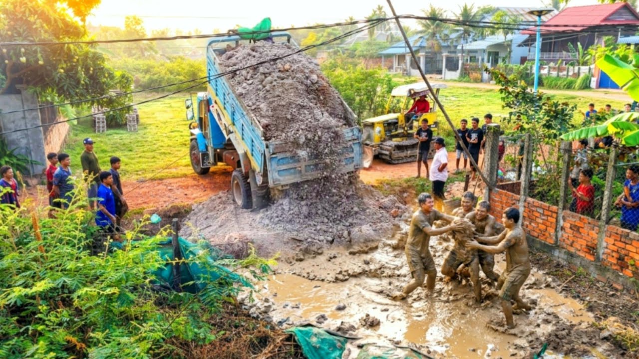 5 Ton Truck Dumping Soil In New Project With Skill Bulldozer KOMATSU D20P Pushing Soil
