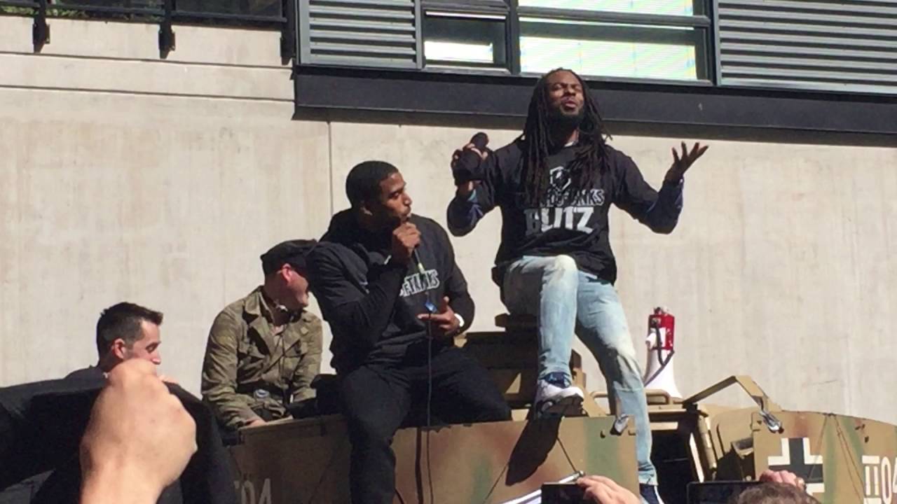 Richard Sherman and Bobby Wagner telling stories on a tank