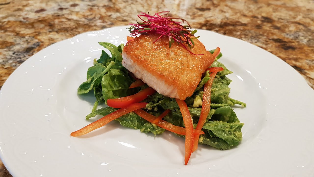 Seared Crispy Salmon over Baby Kale, Chard and Spinach with mashed Avocado/ Lime Puree.