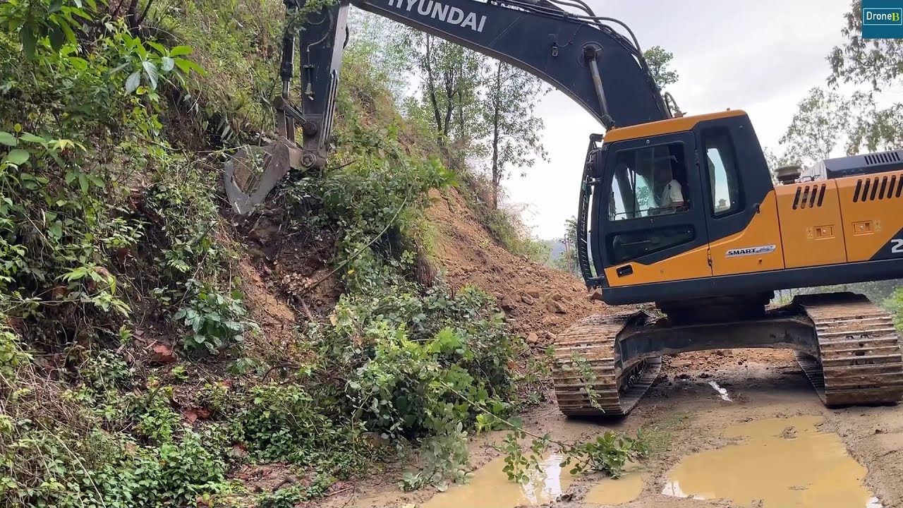 After Rain Cutting a Chunk of Hillside to Widen Mountain Road with Hyundai Excavator