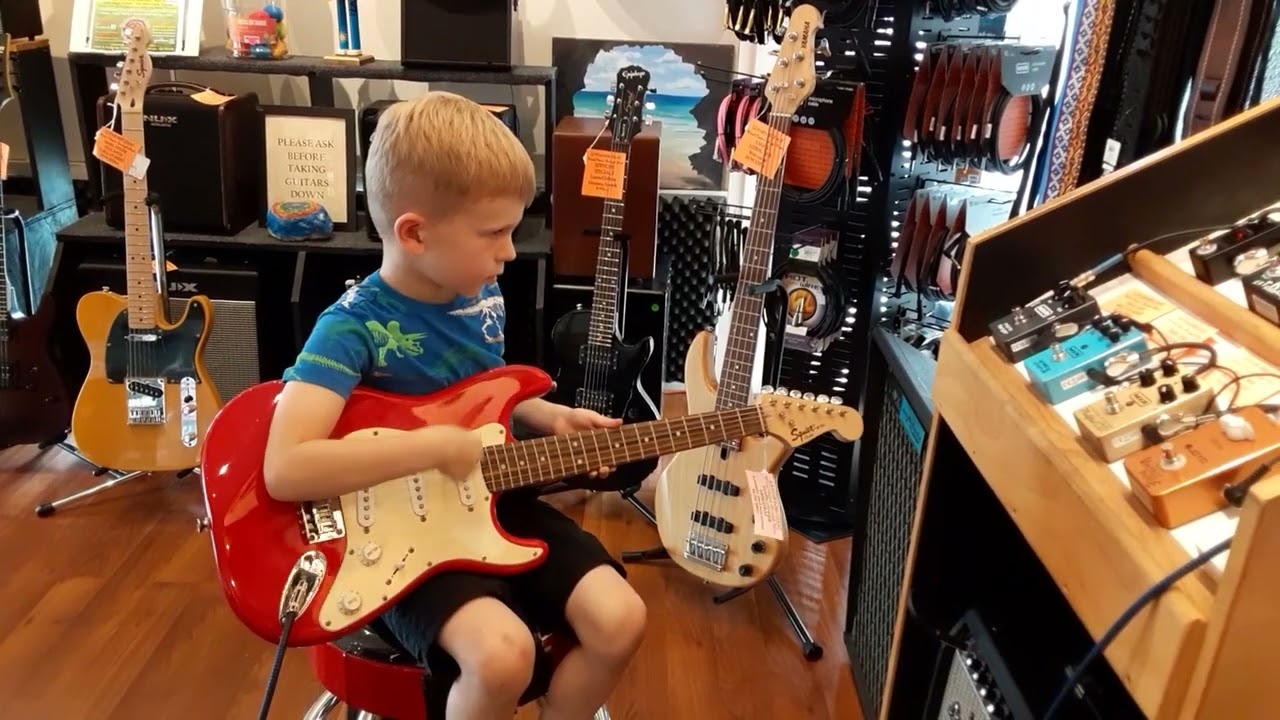 4 year old kid in guitar store getting his 1st taste of heavy metal.