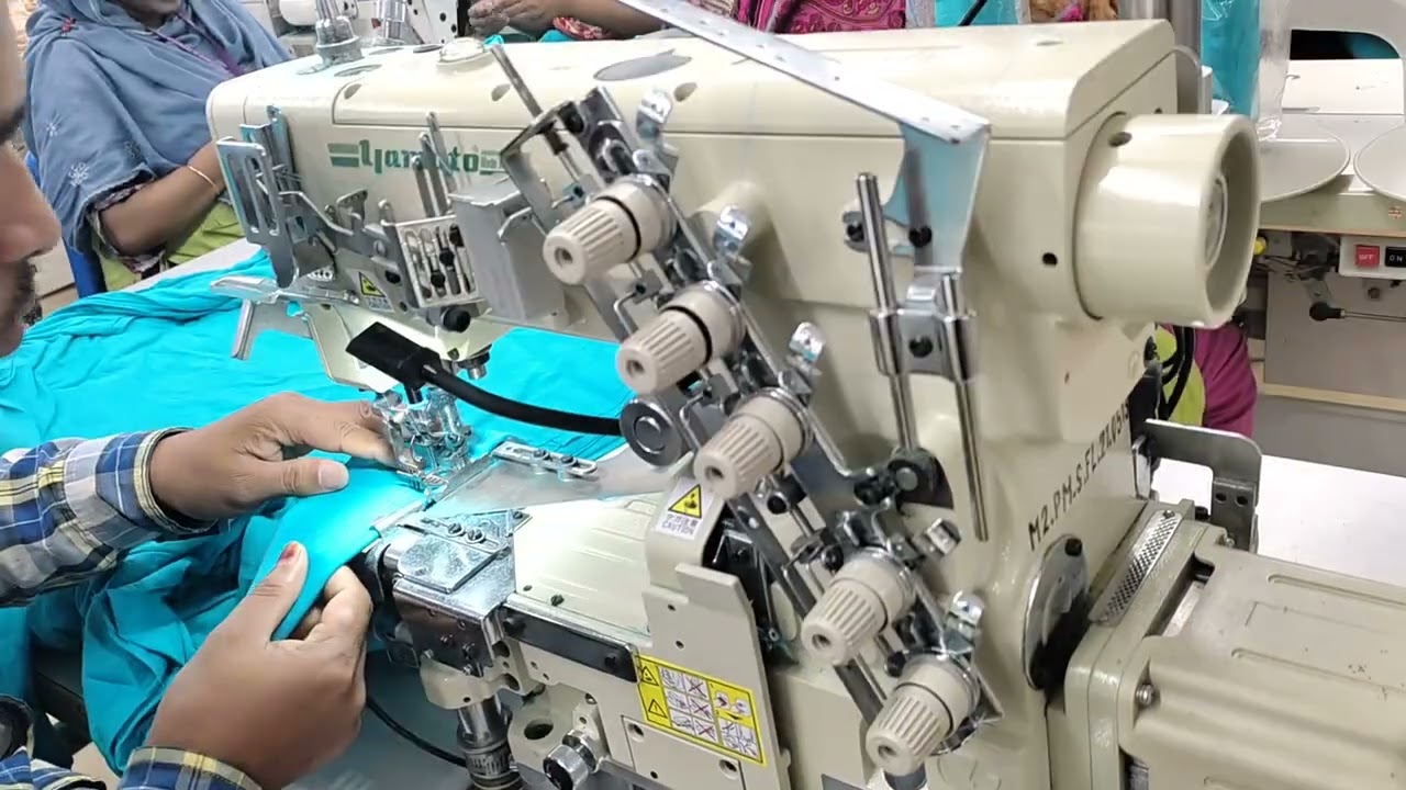 Flatlock sewing machine, bottom hem process of basic t-shirt. A grad very skill operator.