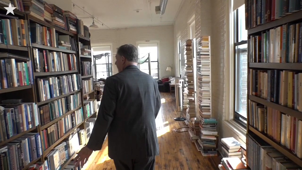 Floor to ceiling books fill Kemper's loft home