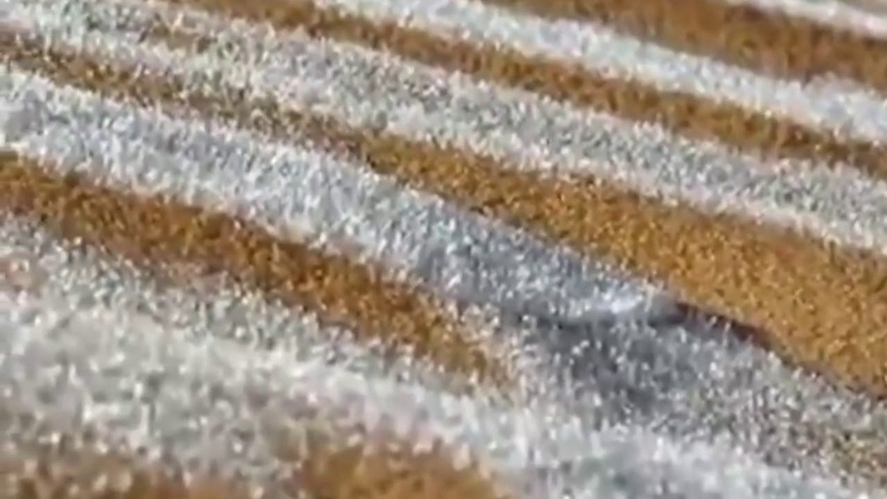 Icy patterns formed on sand dunes outside Saharan town of Ain Sefra in Algeria after rare snowfall.