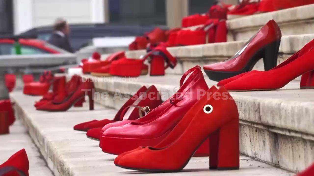 Red shoes on steps of Bucharest concert hall represent victims of domestic violence