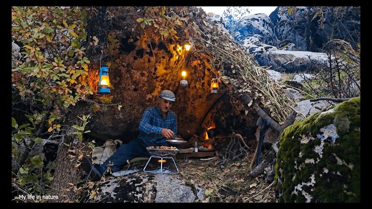 Sheltering under a large rock, surrounded by wild nature, cooking and sleeping overnight