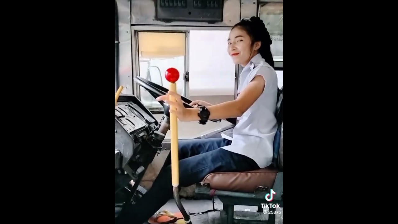 Girl pedal pumping and flooring an old bus barefoot.
