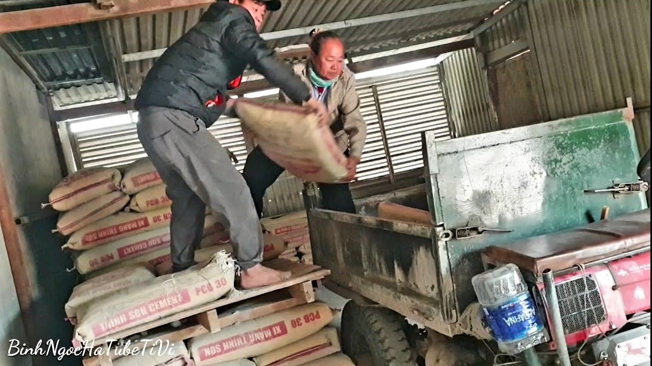 An elderly woman in her 70s is incredibly strong at loading cement onto a tractor