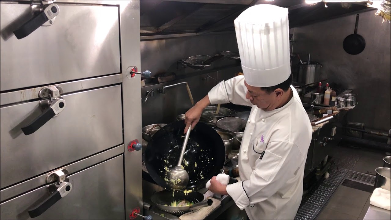 Chef Jian Chit Ming prepares a fried rice dish at 2 Michelin star Canton 8 in Shanghai, China