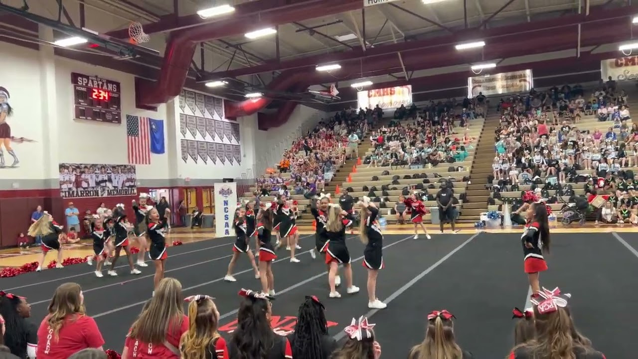 Aria and her Pinecrest Cadence ES Cheer Team last competition of the season