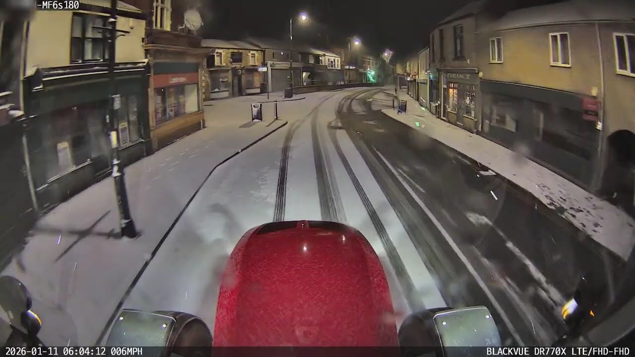 Tractor gritting roads slides in town centre NEAR MISS!!