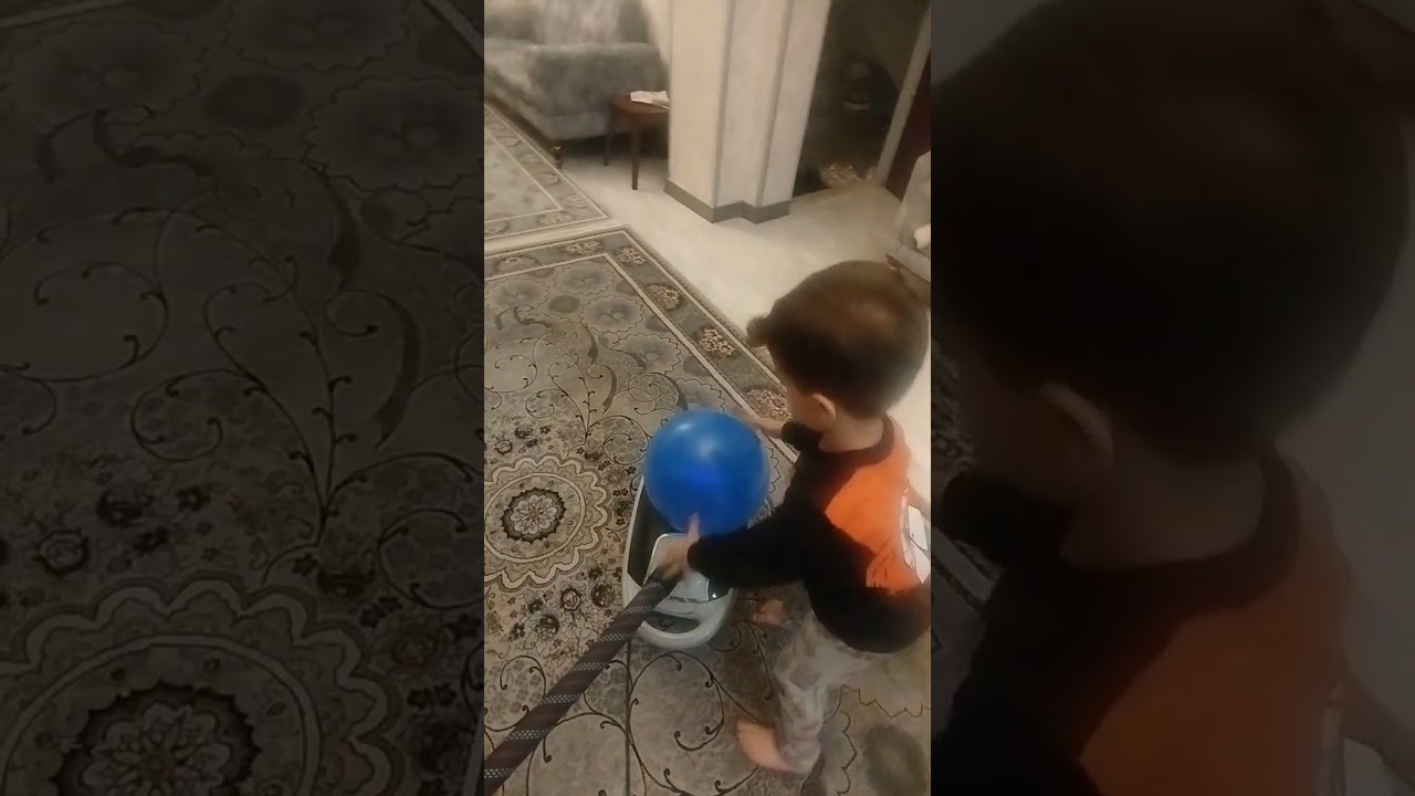 Vihan and Deniz playing with a vacuum cleaner