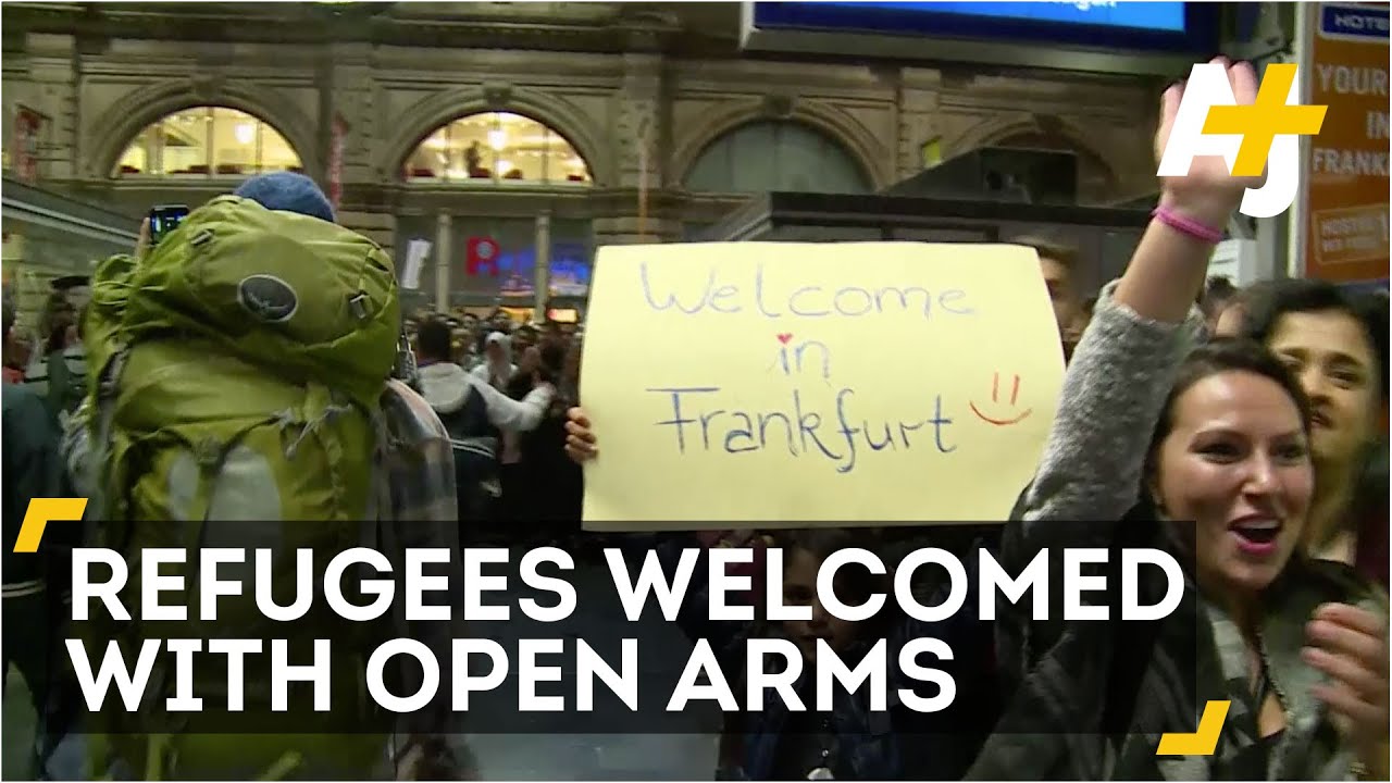 Refugees Arrive In Germany To Cheers